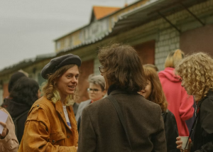 Group of people standing together outdoors in conversation